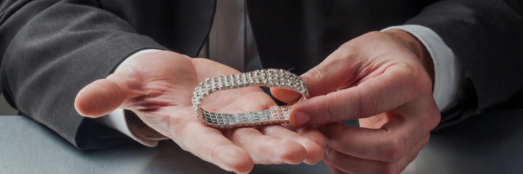 hands holding a diamond barcelet
