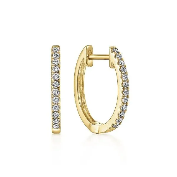 Gold hoop earrings with embedded diamonds. Click to shop earrings.