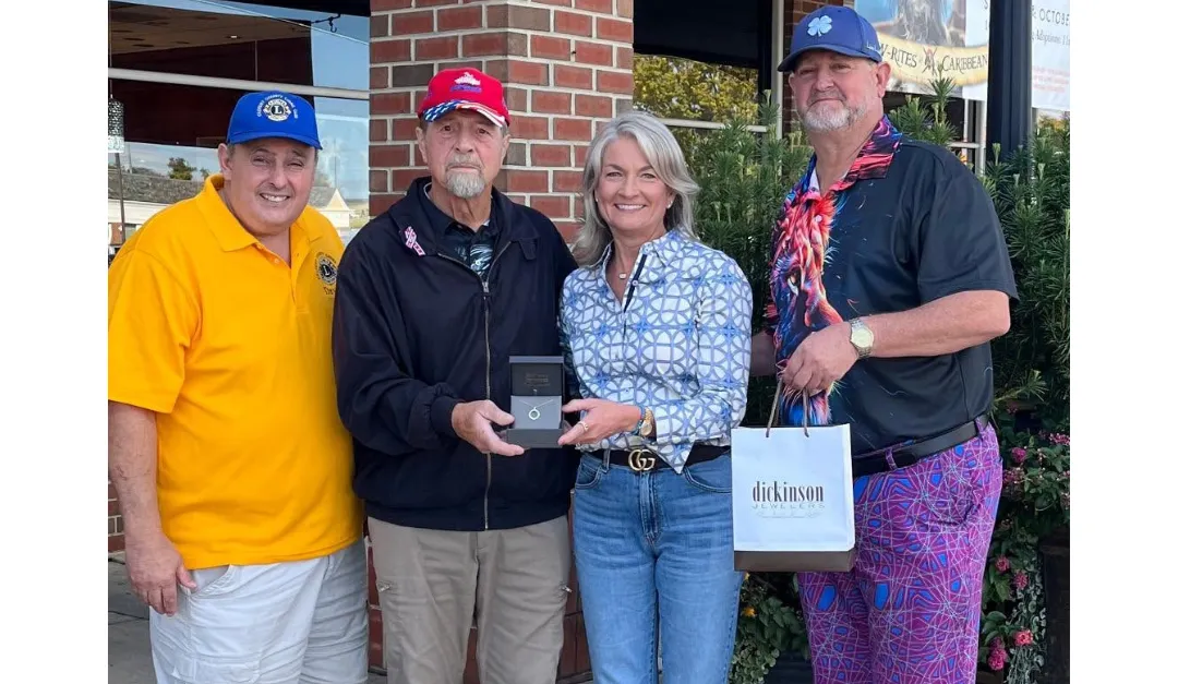 John McGuffin of the Lions Club with Kathy Dickinson and the winner of the 2025 raffle