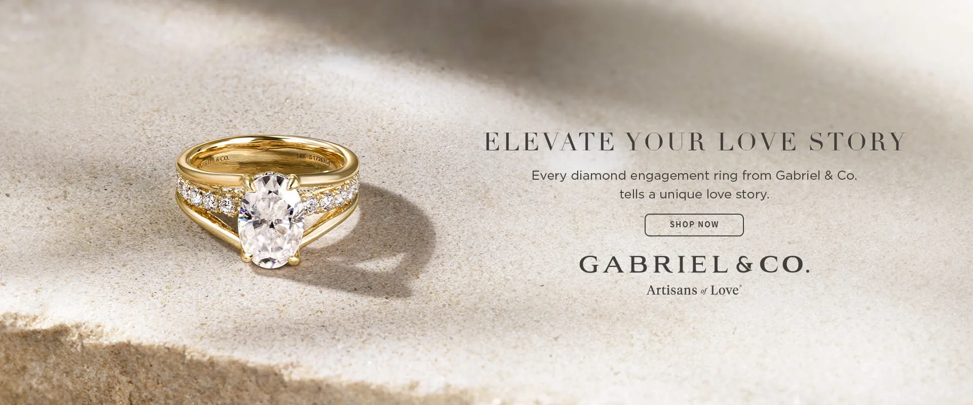 A gold engagement ring with a large diamond and smaller diamonds on a textured surface. Text promotes Gabriel & Co. rings.