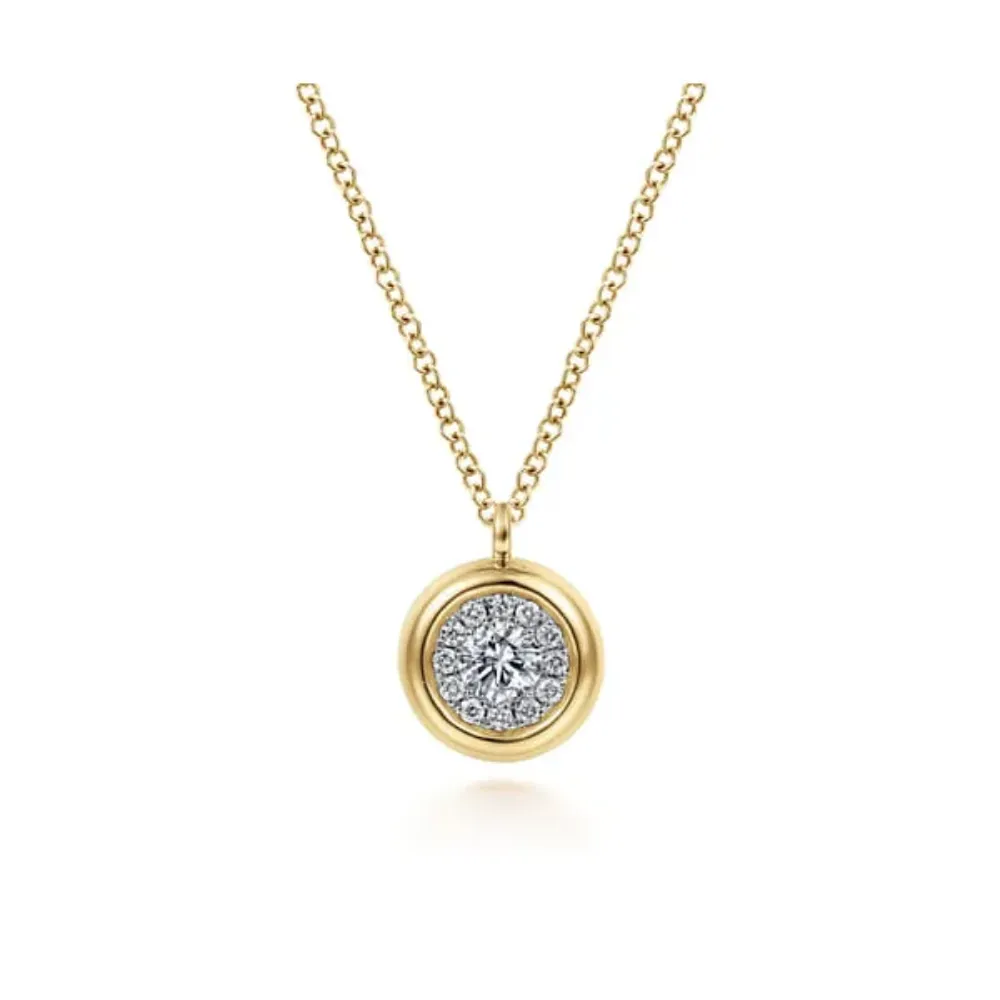 Gold chain necklace with a round diamond pendant. [Shop Pendants](#)