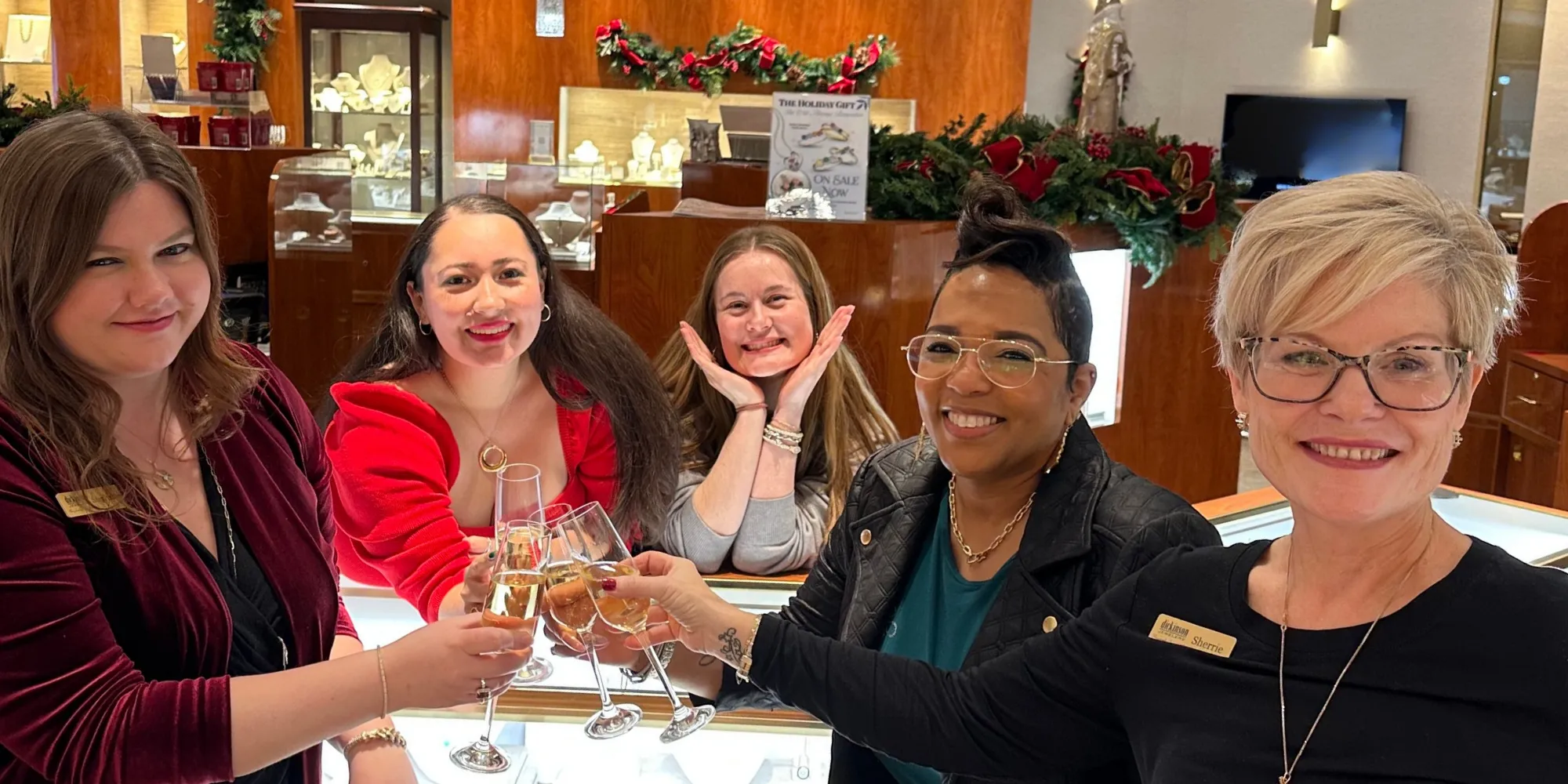 The Dickinson Jewelers team clinking glasses in celebration