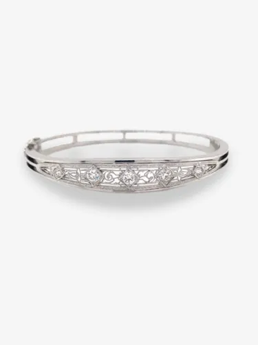 Elegant silver bracelet with intricate design and five sparkling gemstones.