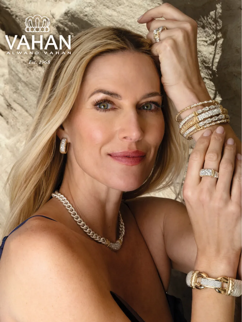 Woman showcasing Vahan jewelry with bracelets, rings, necklace, and earrings.