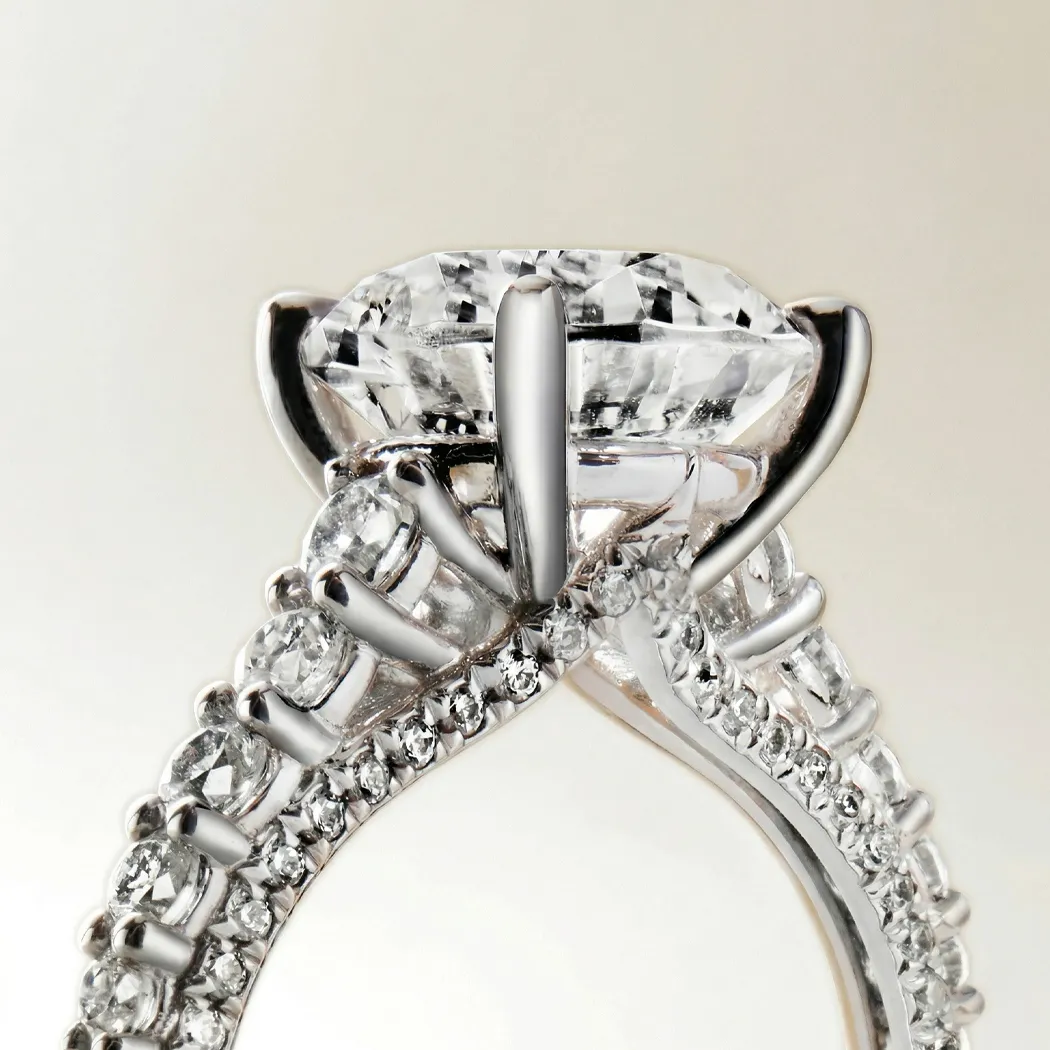 Close-up of a diamond engagement ring with intricate setting and side stones.