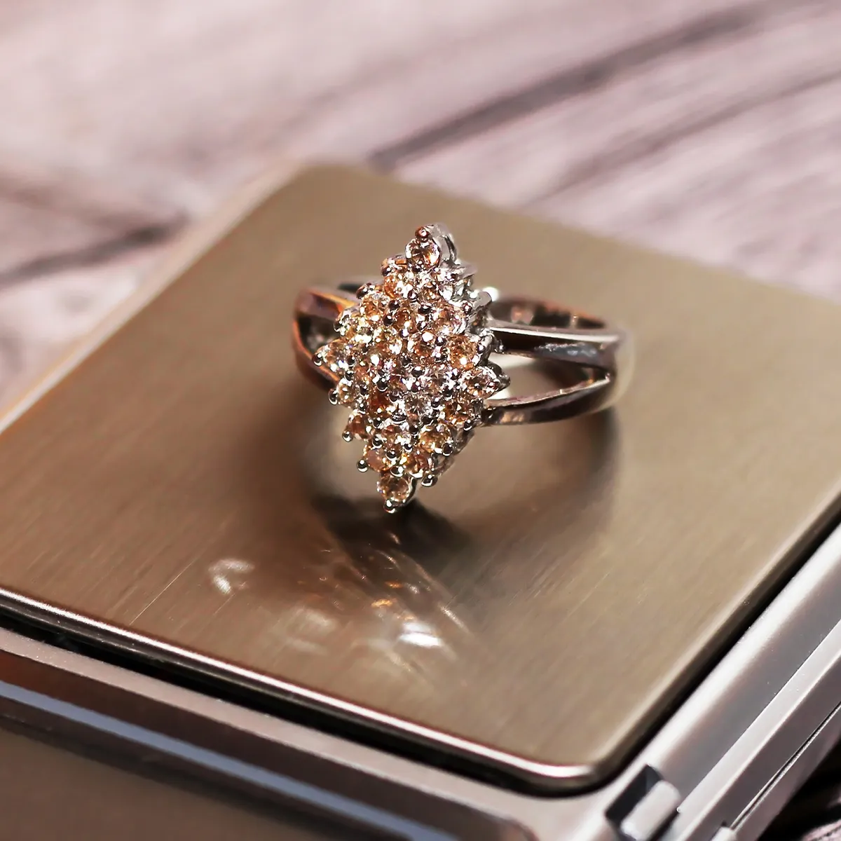 Diamond cluster ring on a reflective surface at Diedrich Jewelers, Ripon.