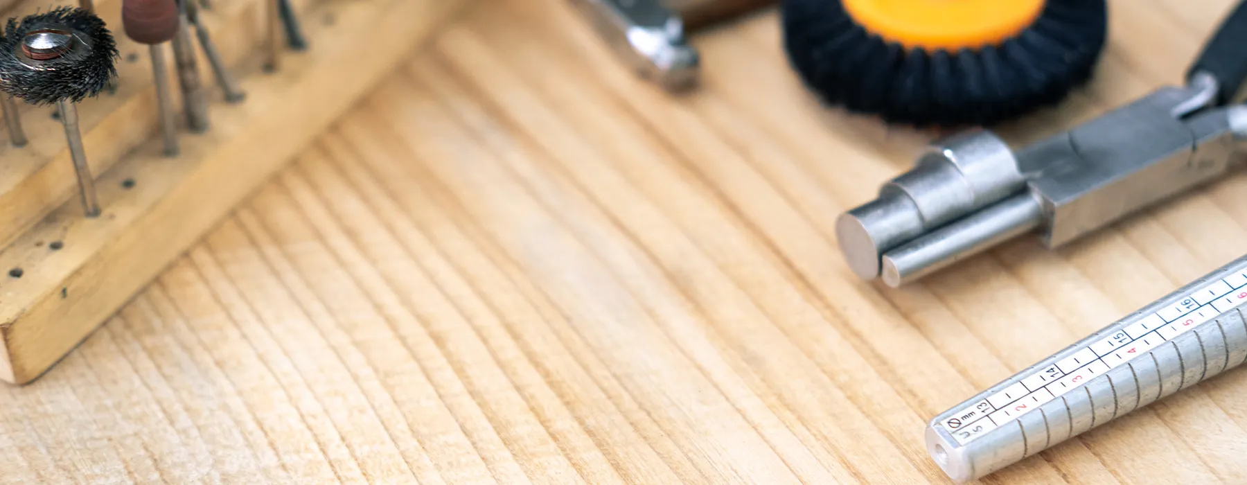 Jewelry tools on a wooden surface. Schedule a consultation at Diedrich Jewelers.