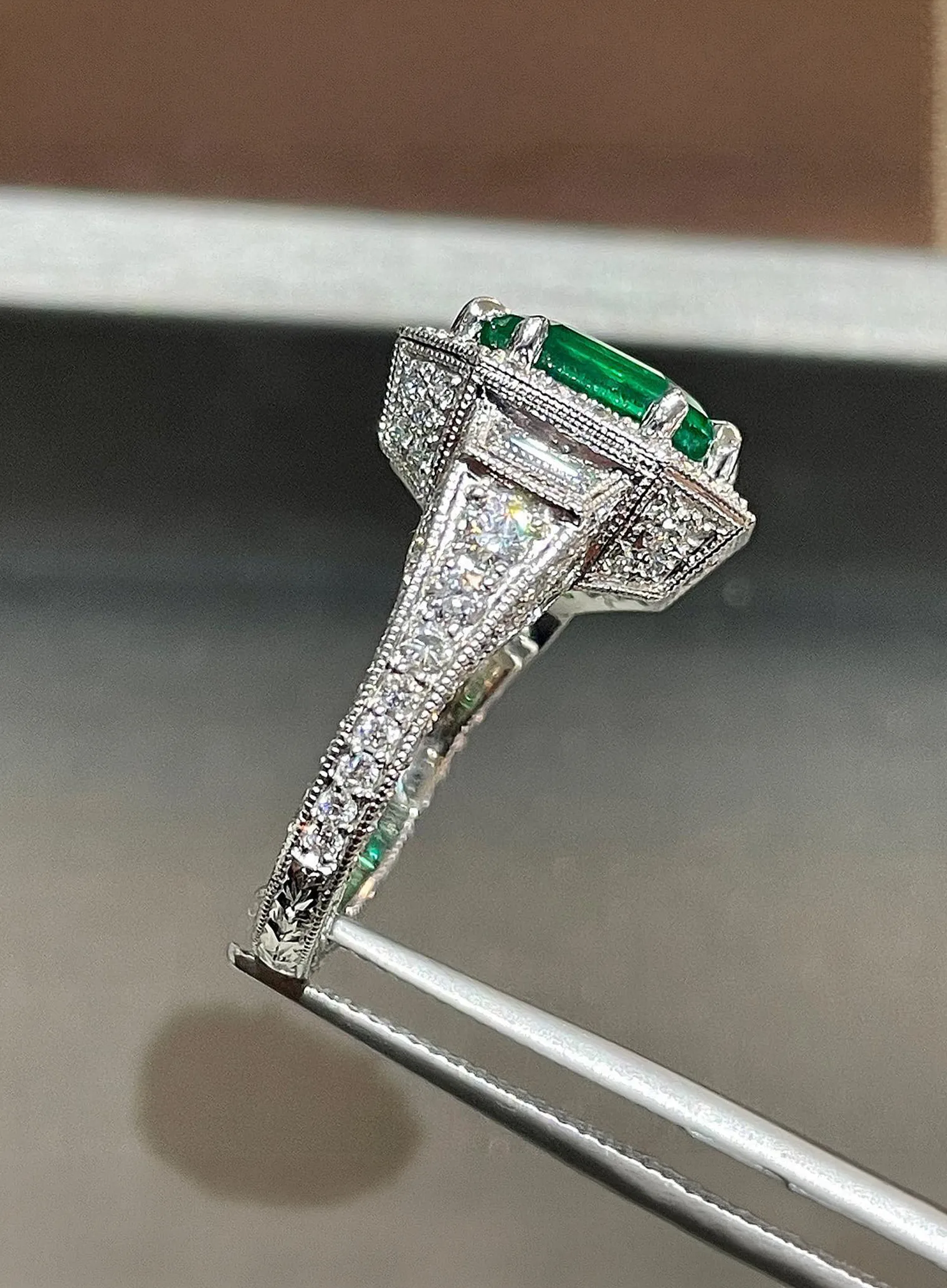 A large diamond ring with a halo of smaller diamonds on a textured background.