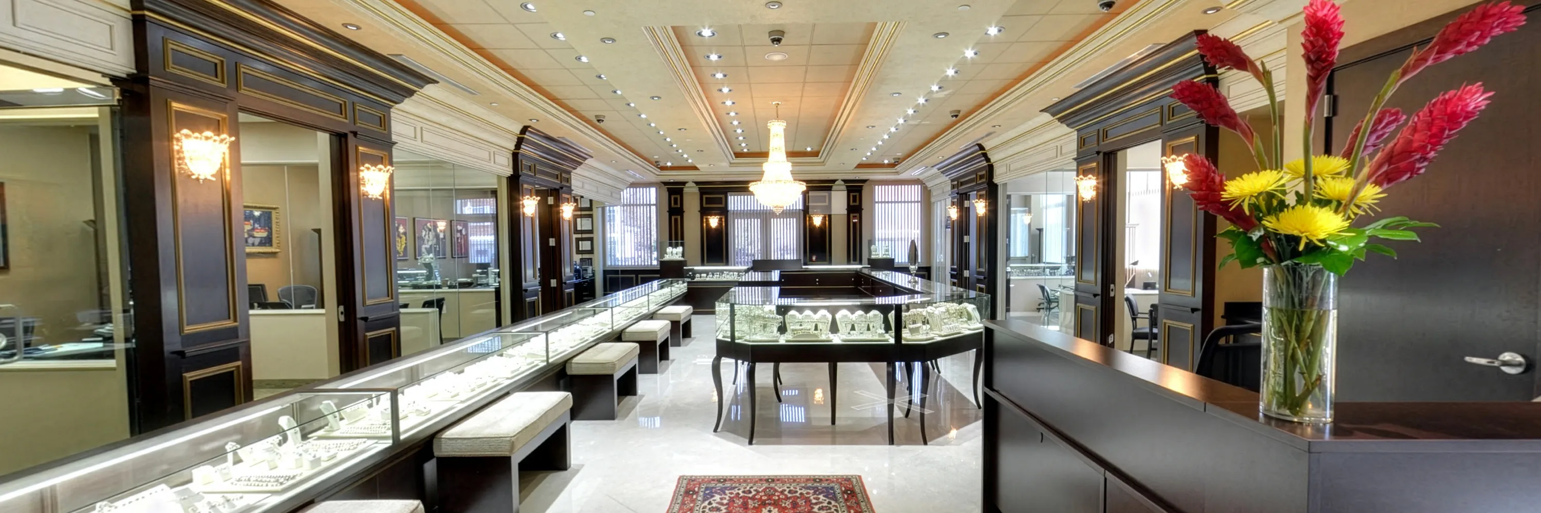 Luxurious jewelry store interior with elegant displays and floral arrangement.
