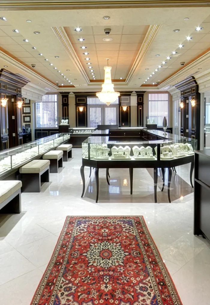Luxurious jewelry store interior with elegant displays and floral arrangement.