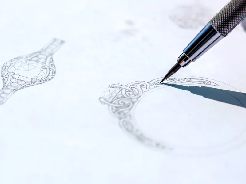 A detailed sketch of a ring design being drawn with a mechanical pencil.