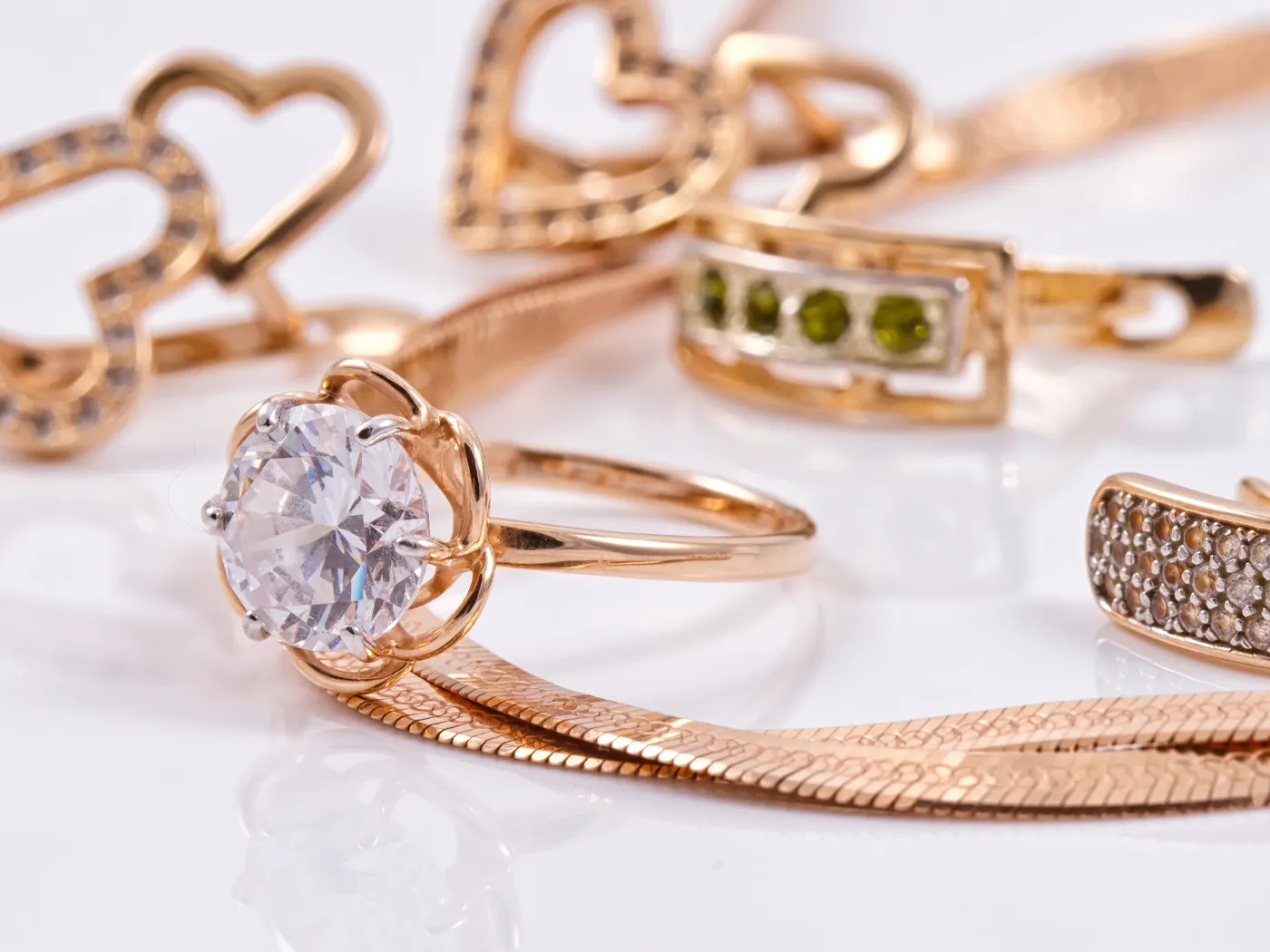Elegant gold jewelry featuring a diamond ring and various stylish bands.