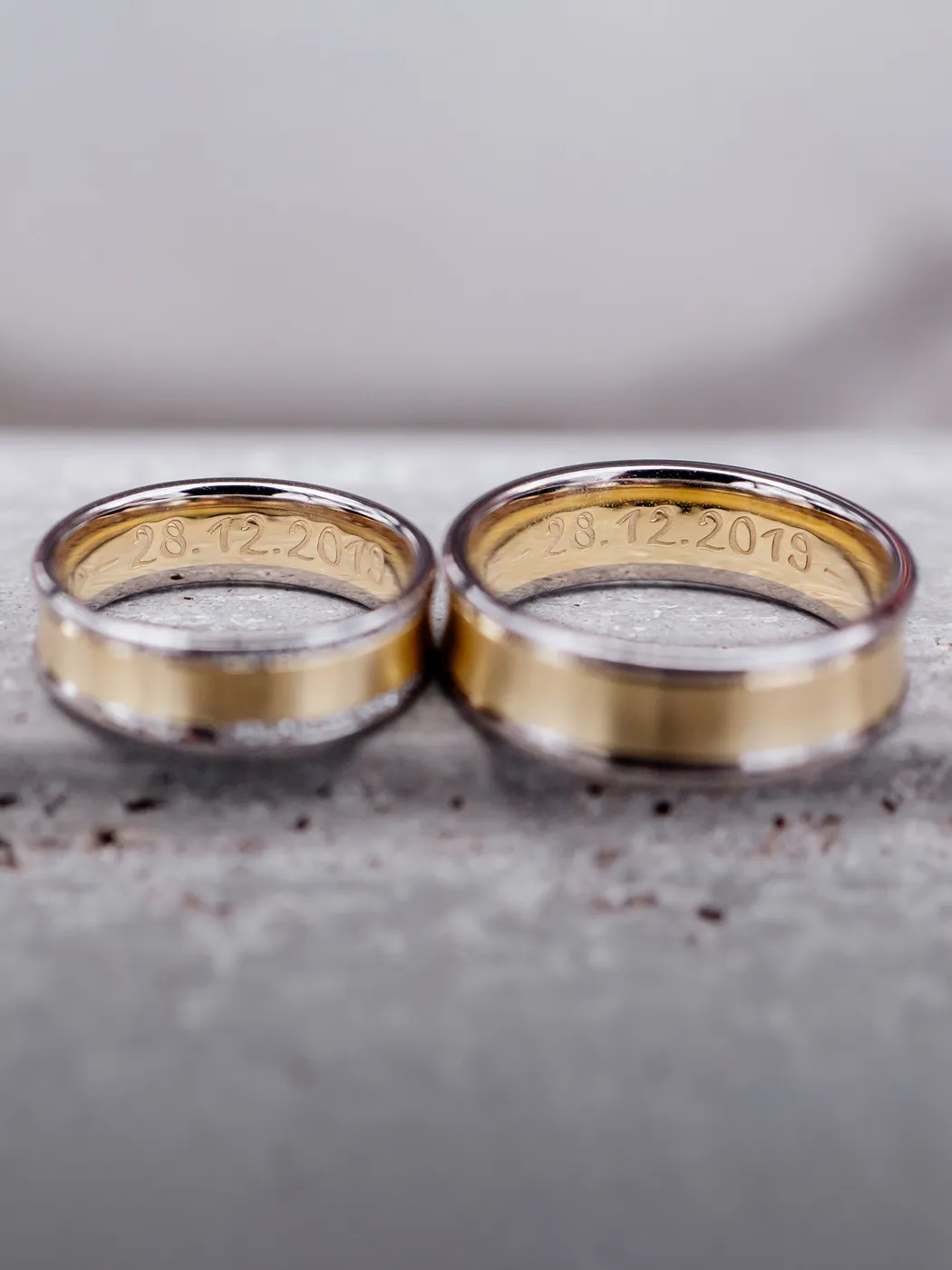 Two gold and silver rings with engraved date