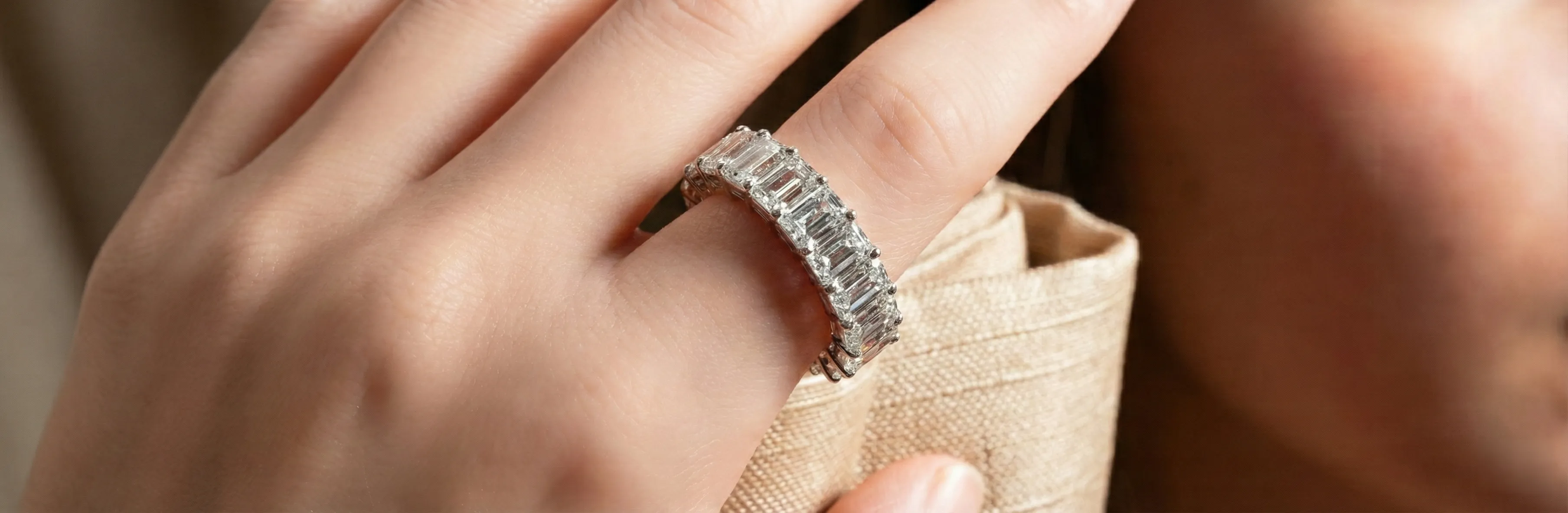 Hand with a textured, sparkling ring.