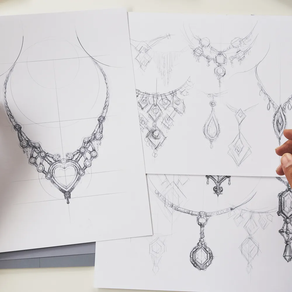 Sketches of intricate jewelry designs, including necklaces with heart and diamond shapes, on white paper.