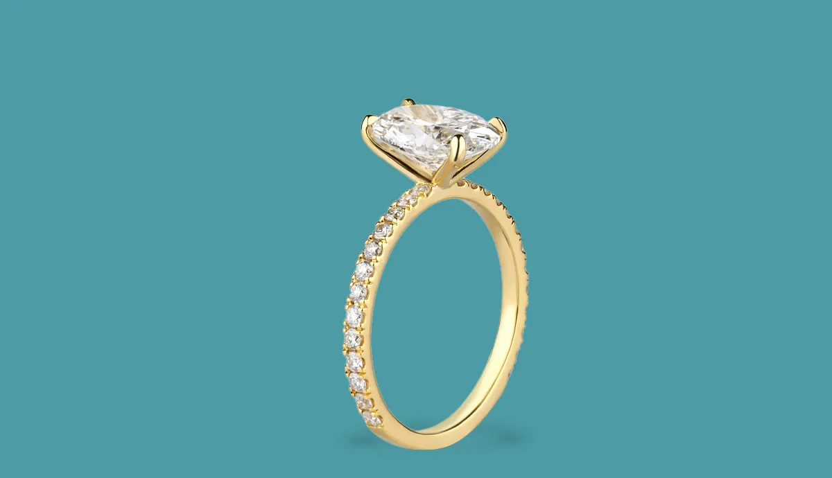Elegant gold engagement ring with a large diamond and smaller stones along the band.
