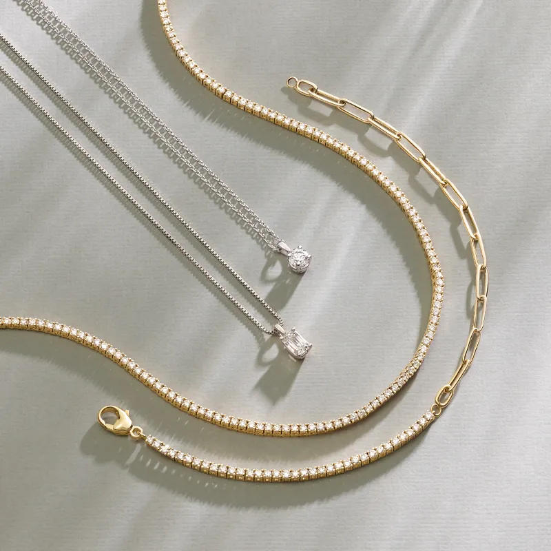 Elegant gold and silver chains displayed on a soft background, showcasing fine jewelry