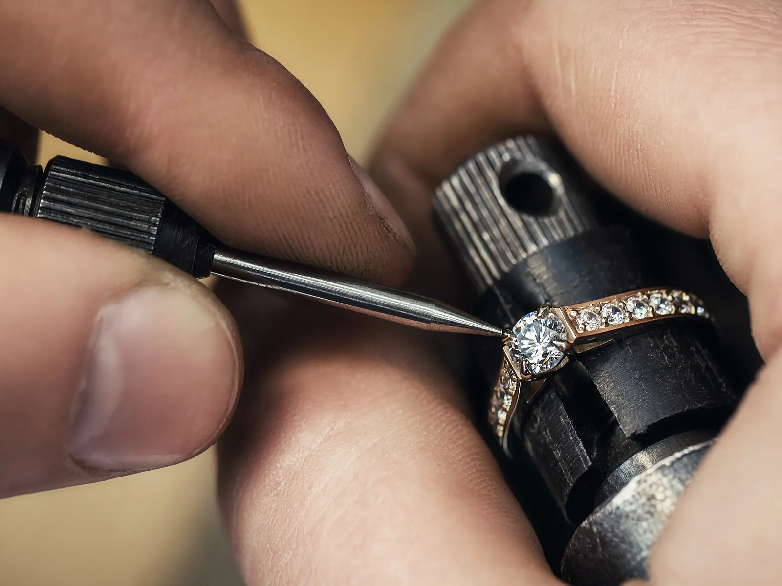 A jeweler carefully setting a diamond on a ring using precision tools at E.G. Landis Jewelers in Gilbertsville.