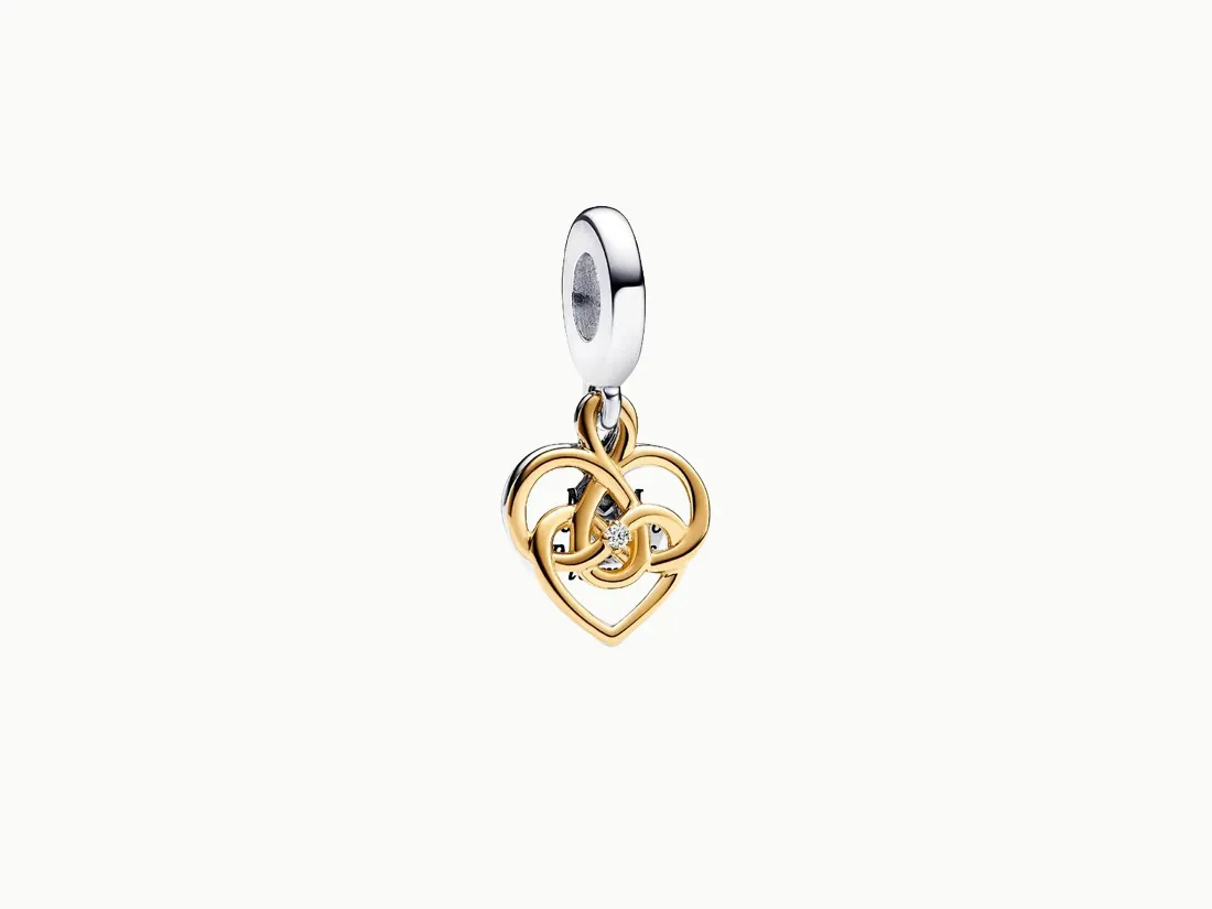 Gold and silver heart charm with intertwined design and a small diamond, available at E.G. Landis Jewelers. Click for charms.
