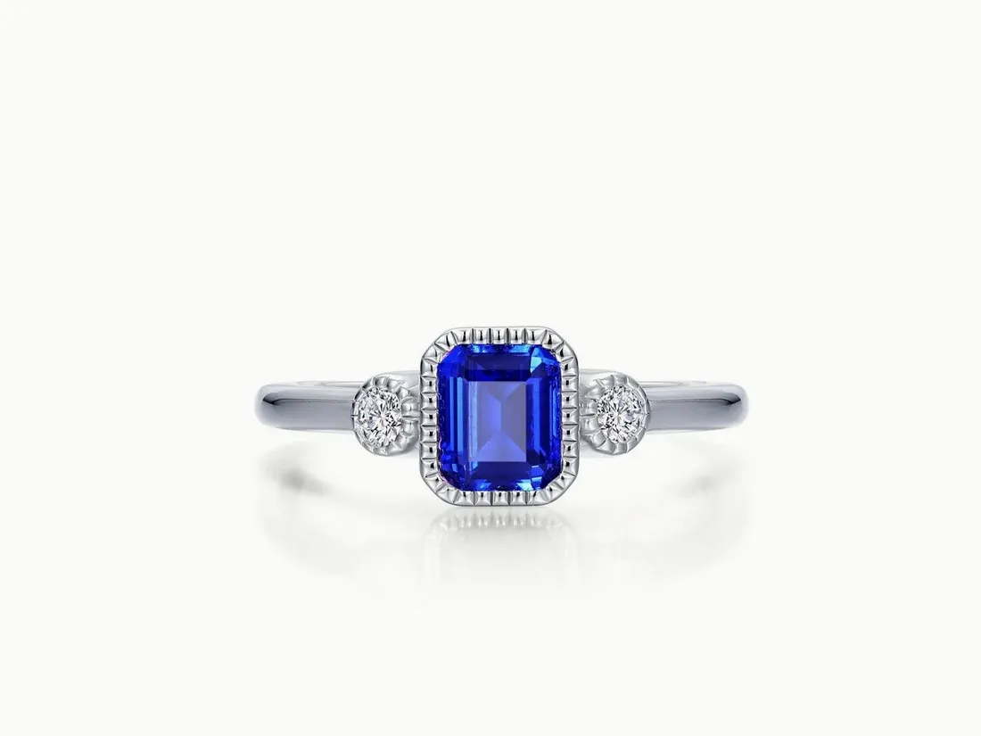 Elegant blue gemstone ring with diamond accents, available at E.G. Landis Jewelers. Click to view more rings.