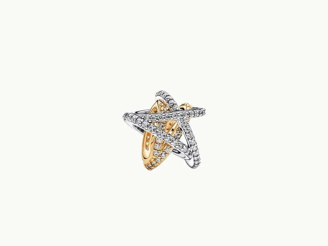 Stylish intertwined ring featuring silver and gold tones with sparkling stones.