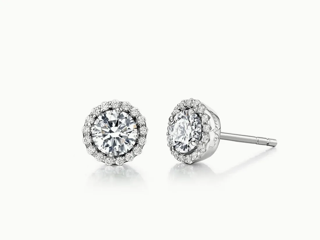 Elegant diamond stud earrings with a halo design, perfect for any occasion. Click to explore more earrings.