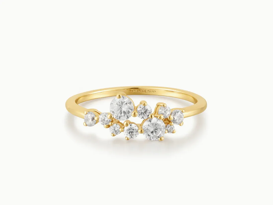 Gold ring with multiple sparkling diamonds, perfect for engagement or special occasions. Click to explore more rings.