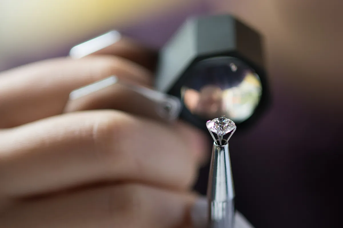 Two elegant rings displayed in hexagonal velvet boxes, featuring a gold band and a diamond engagement ring.
