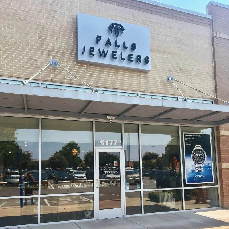 Falls Jewelers storefront in Concord, NC, showcasing engagement rings and fine jewelry.
