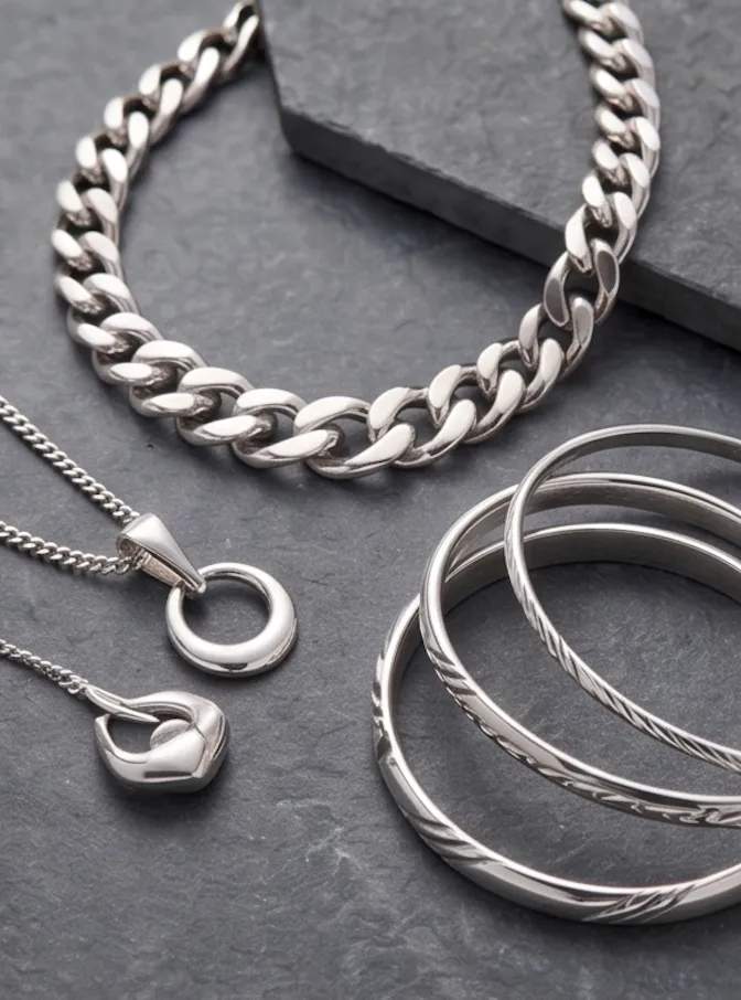 Silver jewelry pieces on a white background
