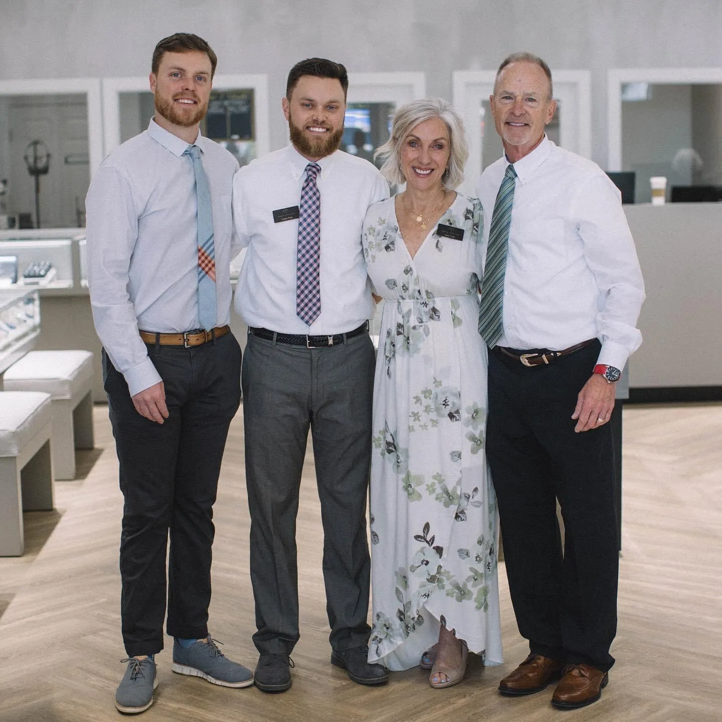 Falls Jewelers team posing together in a jewelry store, showcasing a friendly and professional atmosphere.