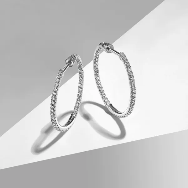 Sparkling diamond hoop earrings displayed on a sleek background. Click to shop diamond jewelry at Falls Jewelers.