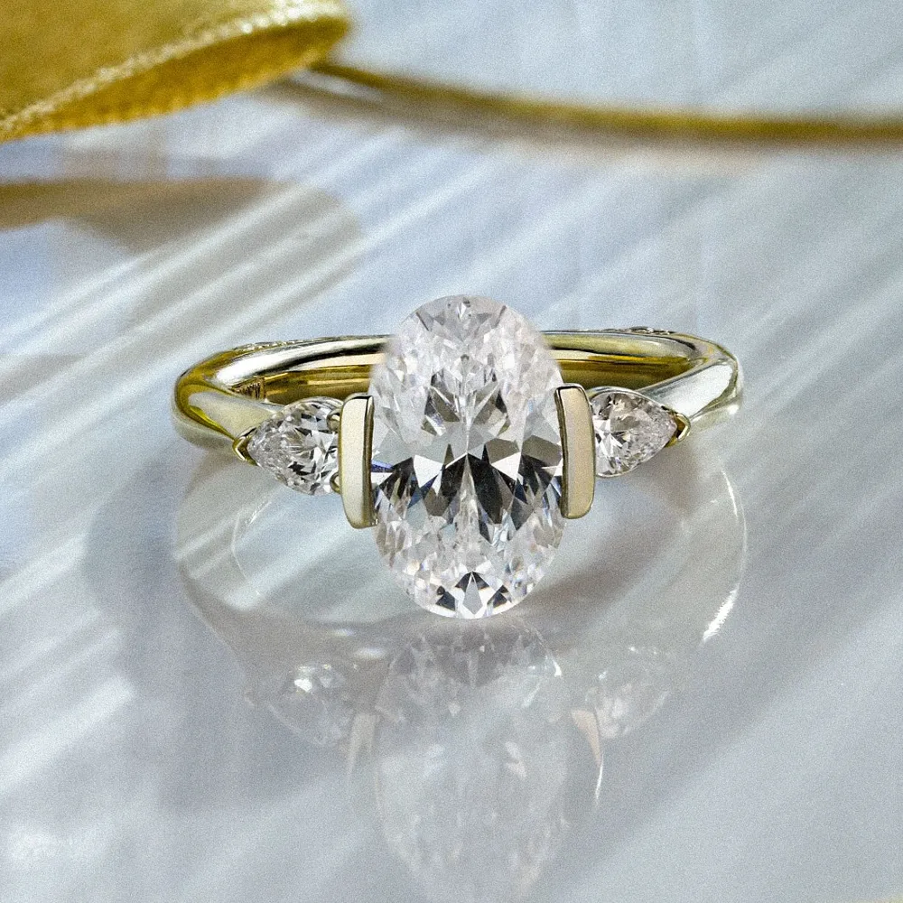Elegant oval diamond engagement ring with side stones, set in a gold band.
