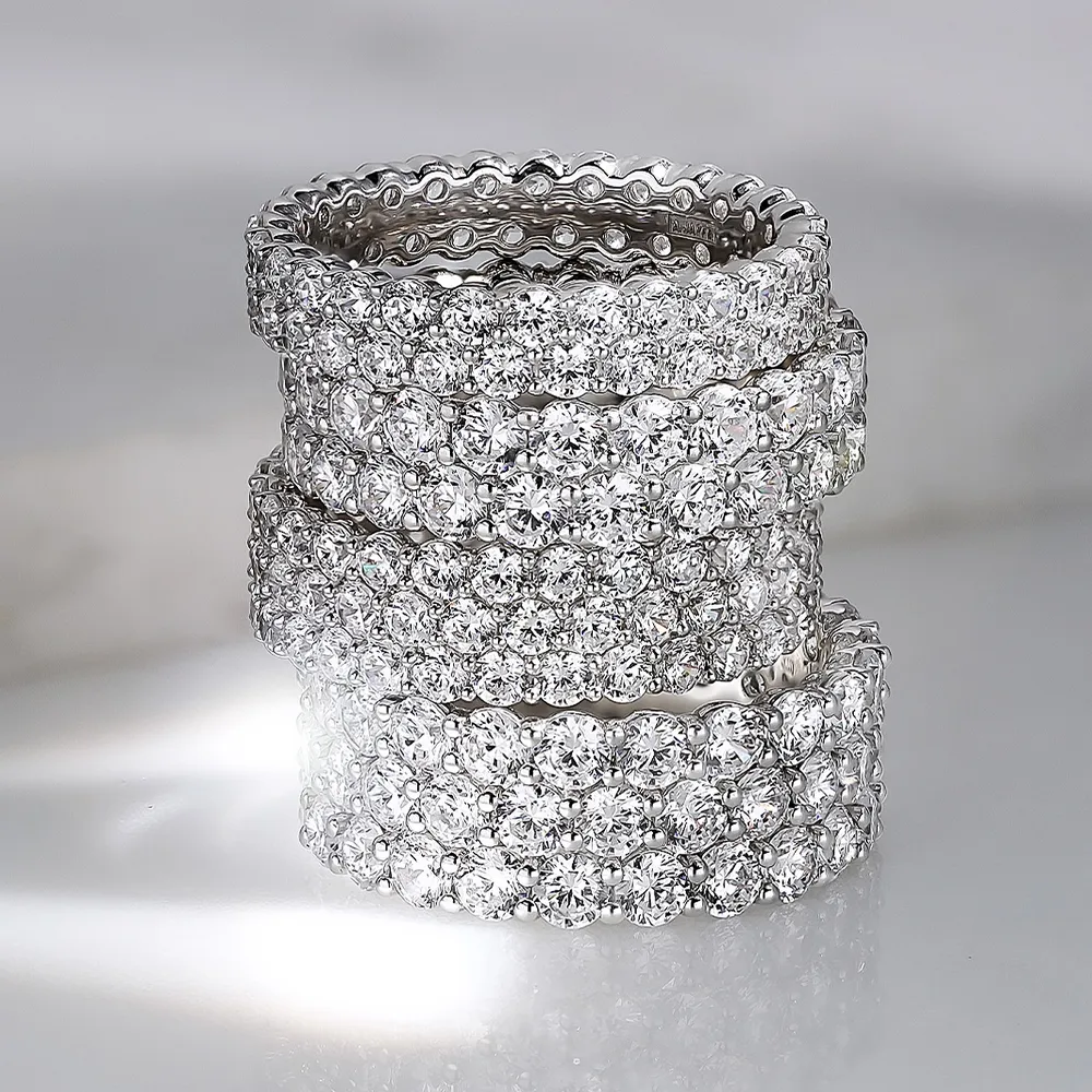 Four sparkling diamond wedding bands stacked together, showcasing their brilliance and elegance.