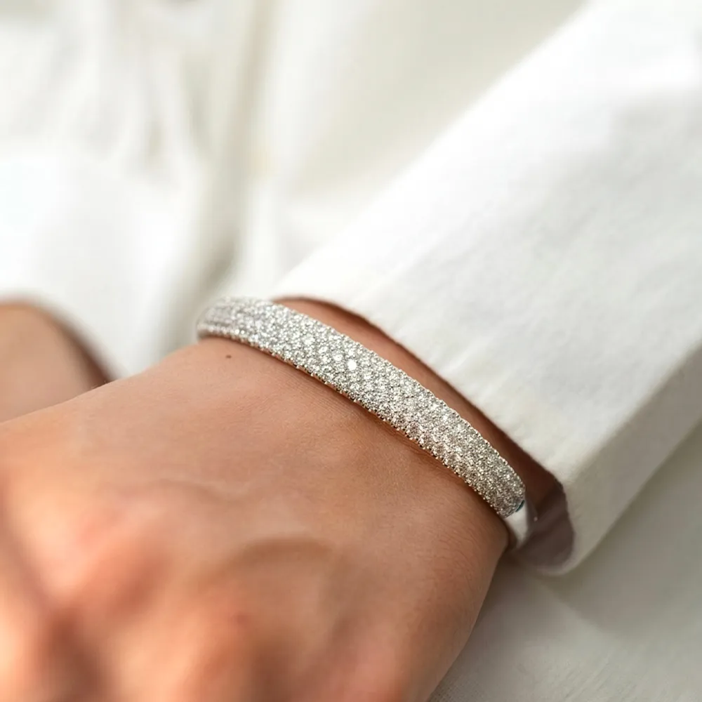 Sparkling silver bracelet worn on a wrist, showcasing a glittering design.