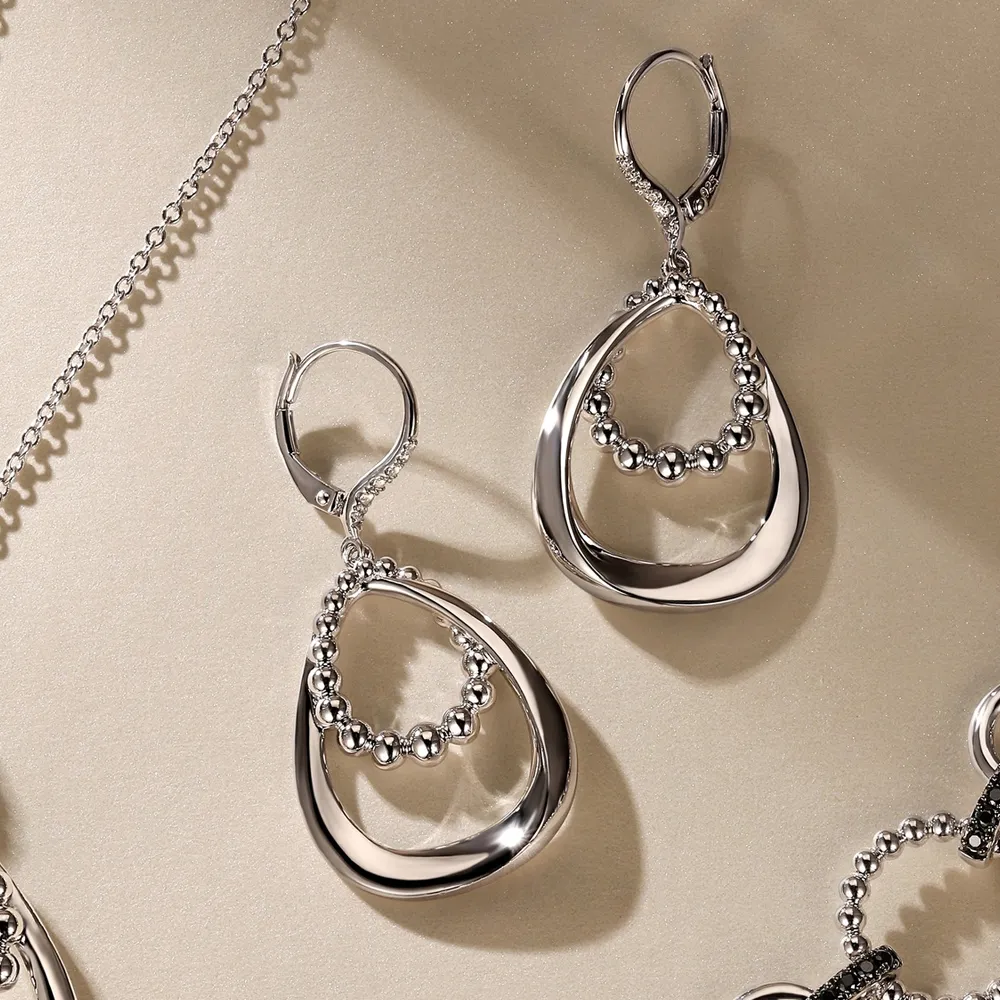 Stylish silver earrings with a teardrop design and bead accents, perfect for any occasion.