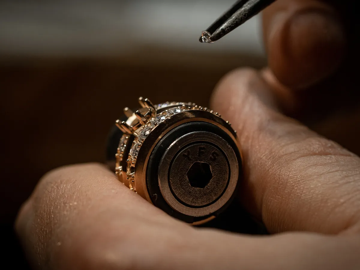 A jeweler carefully assembles a watch movement, highlighting intricate craftsmanship and attention to detail.