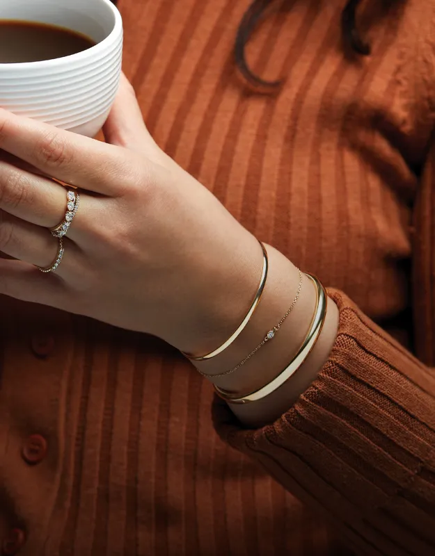 Elegant bracelets with sparkling stones on a woman's wrist.