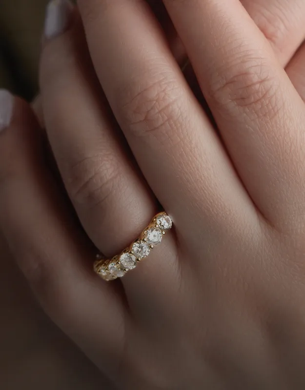 Elegant gold wedding band with sparkling diamonds, showcasing a beautiful design.