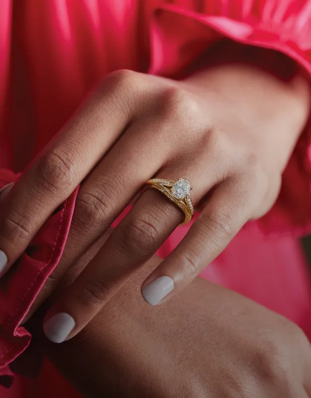 Woman showcasing a diamond engagement ring and necklace.