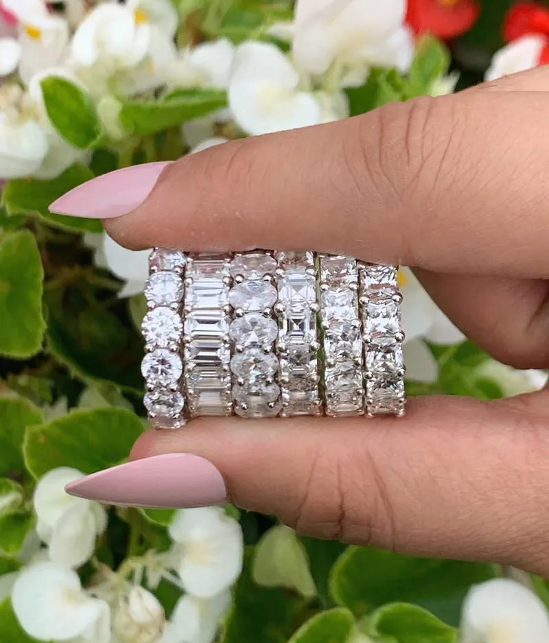 Diamond rings held in hand with floral background. Click to Shop Now at Futer Bros Jewelers.