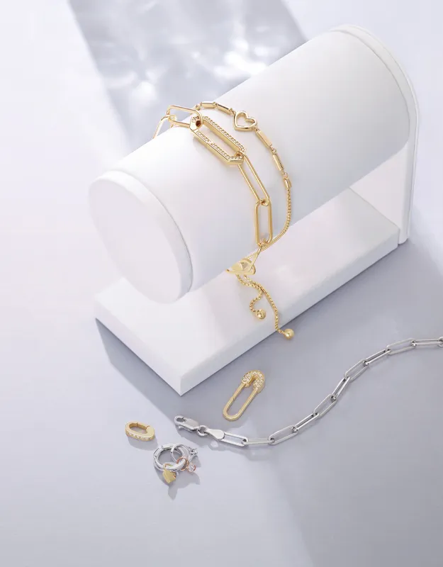 Gold and silver jewelry chains displayed on a white stand. Click to explore chains at Futer Bros Jewelers.
