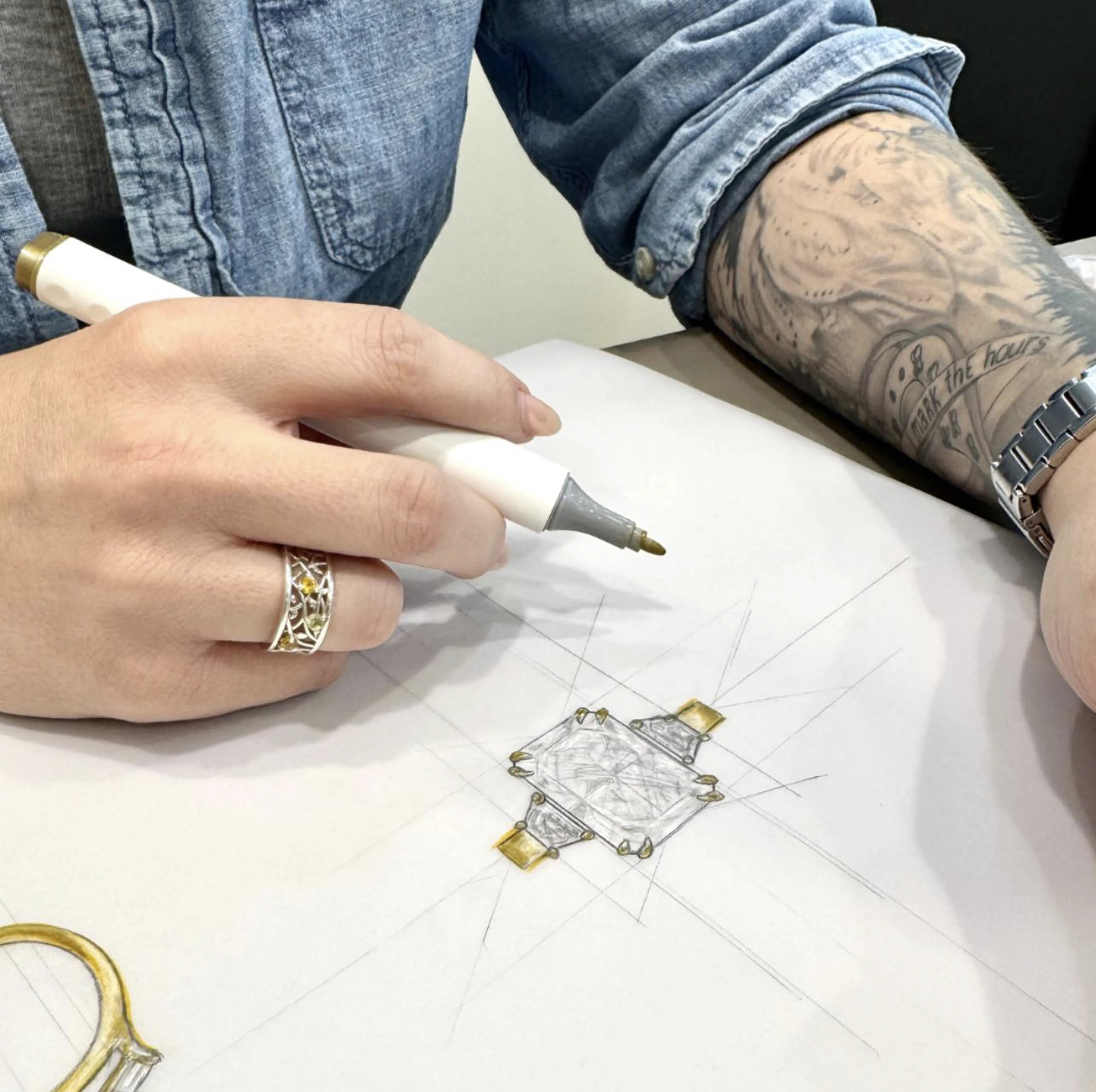 Close-up of hands with elegant rings, including a diamond engagement ring.