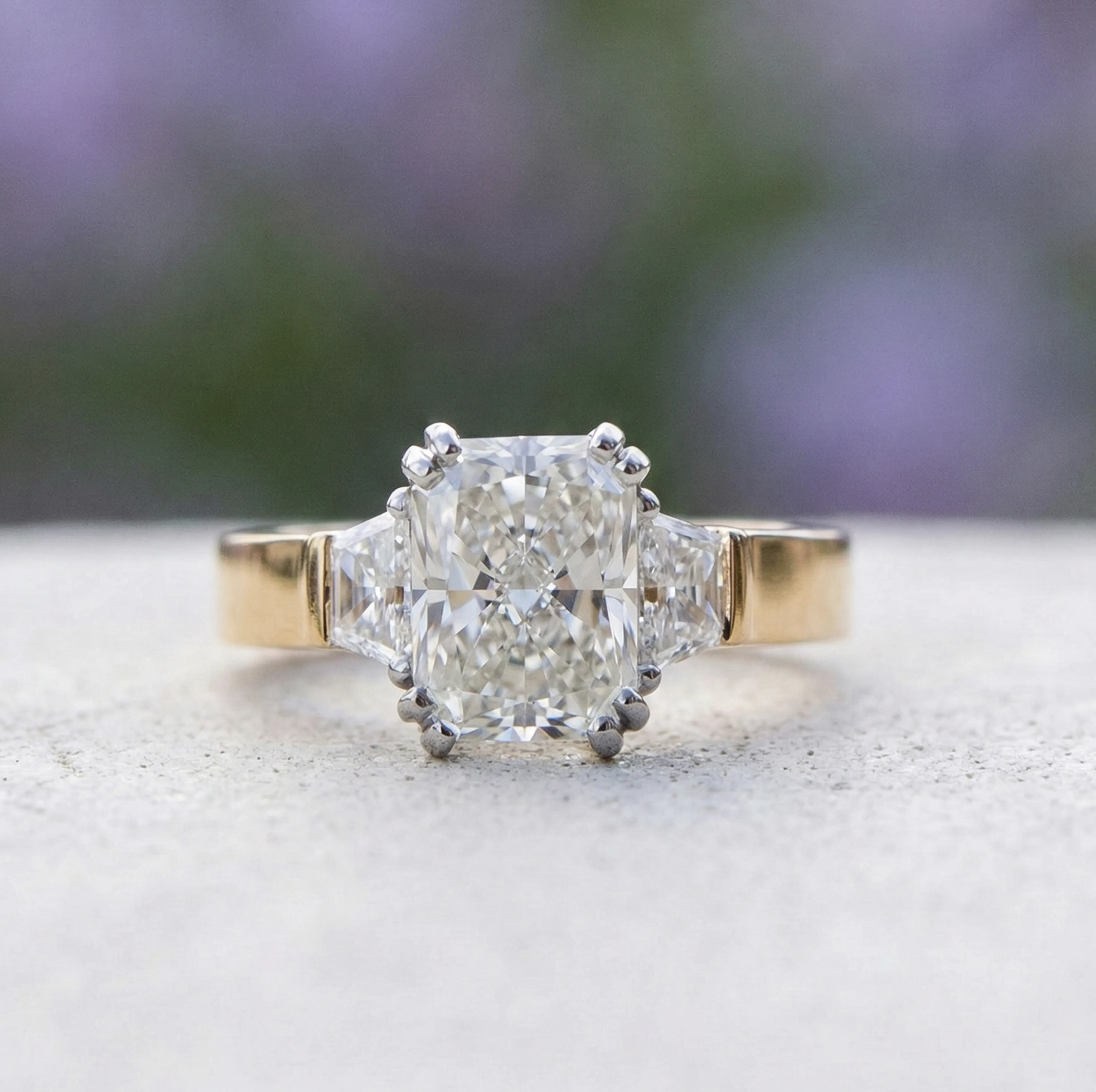 A solitaire diamond ring on a textured white fabric background.