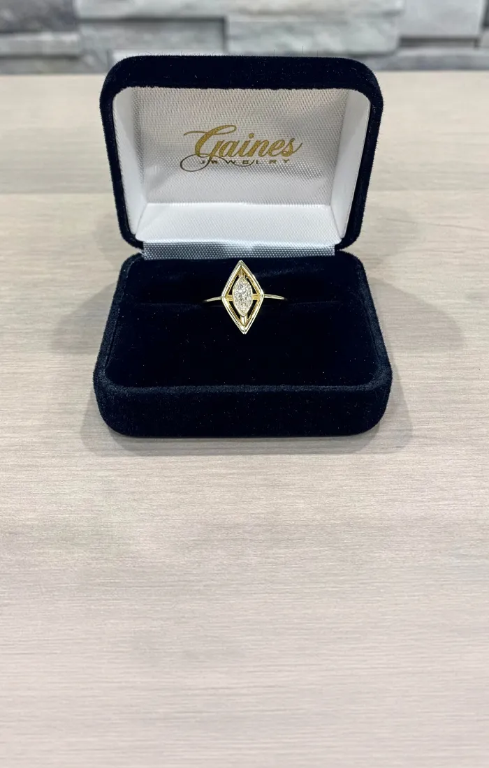 A marquise diamond ring in a black velvet box from Gaines Jewelry.