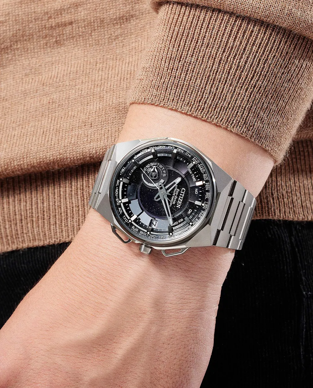 Stylish silver watch with a complex dial on a wrist.