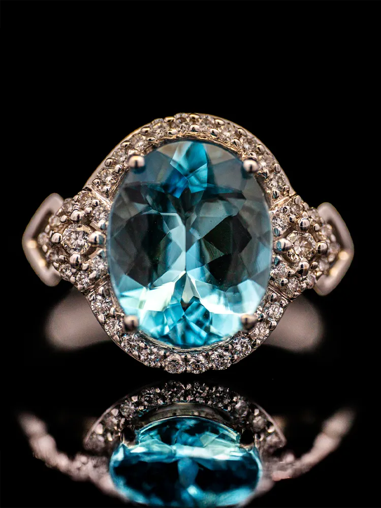 Elegant gold ring featuring a large pink gemstone surrounded by sparkling diamonds, perfect for special occasions.