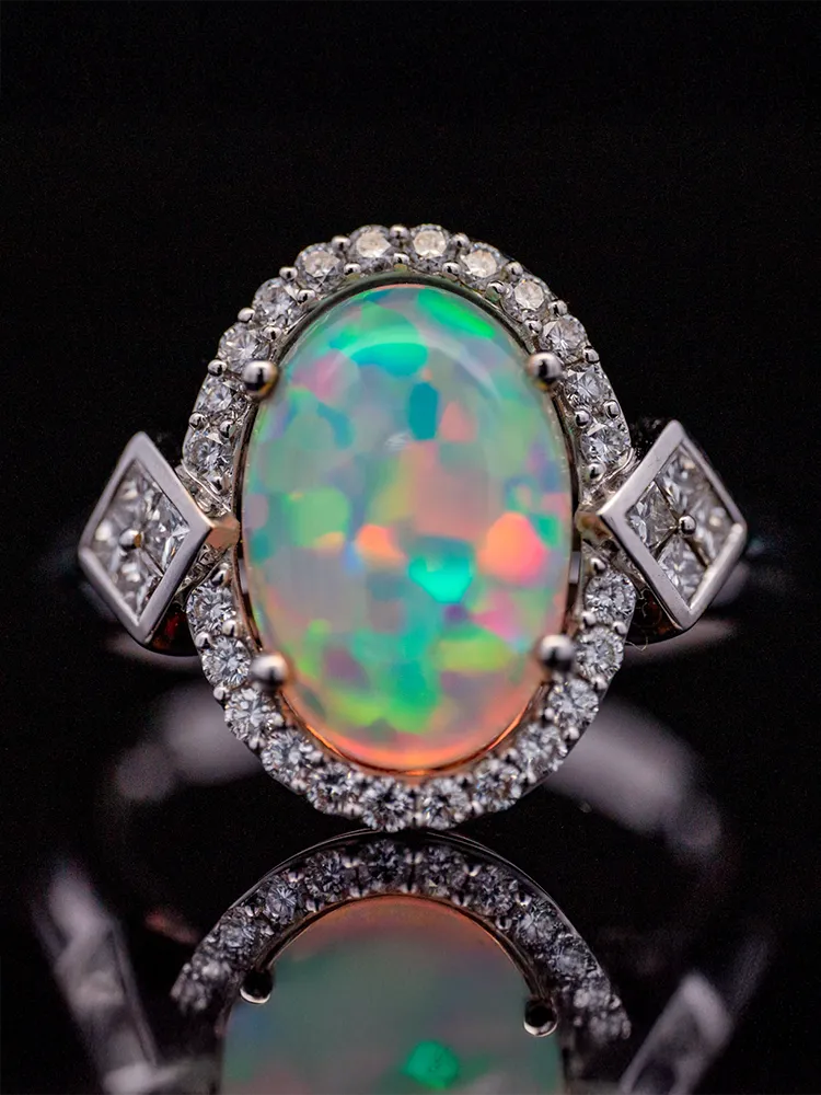 Elegant gold pendant featuring a pear-shaped pink gemstone surrounded by sparkling diamonds.