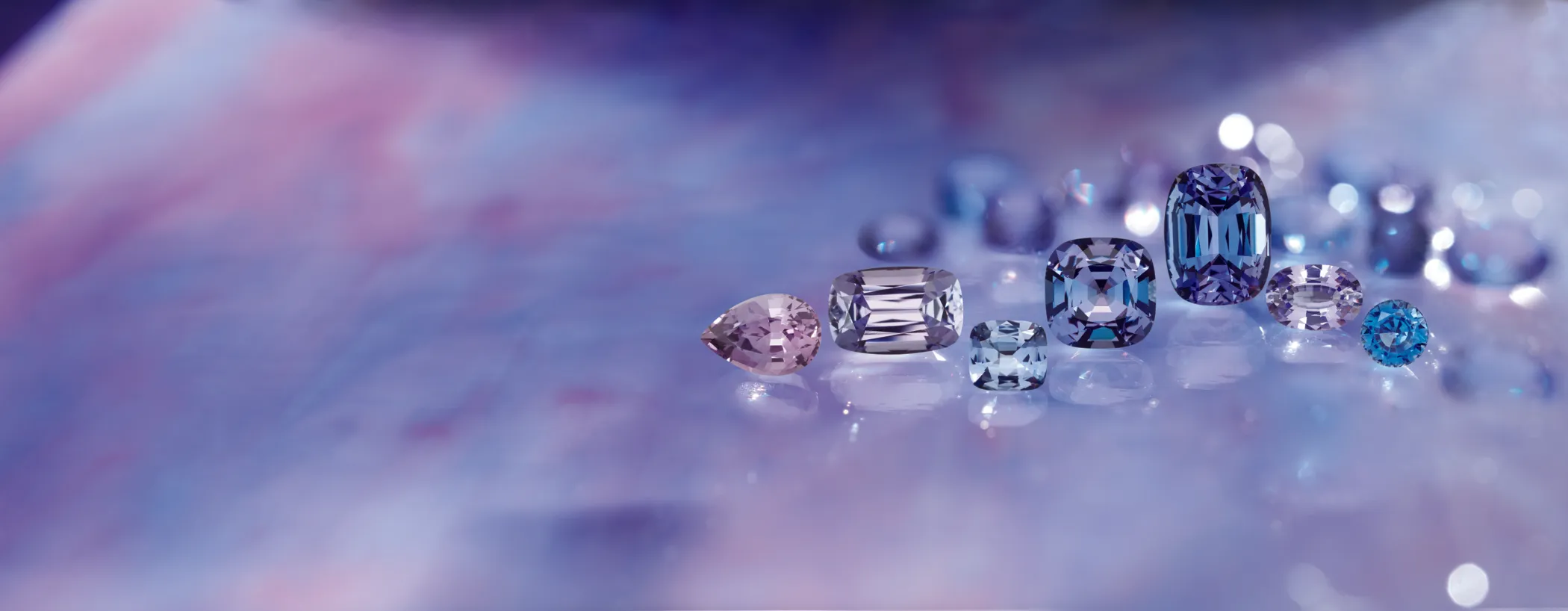 Tanzanite gemstone on a white surface, showcasing its vibrant blue-violet hue.