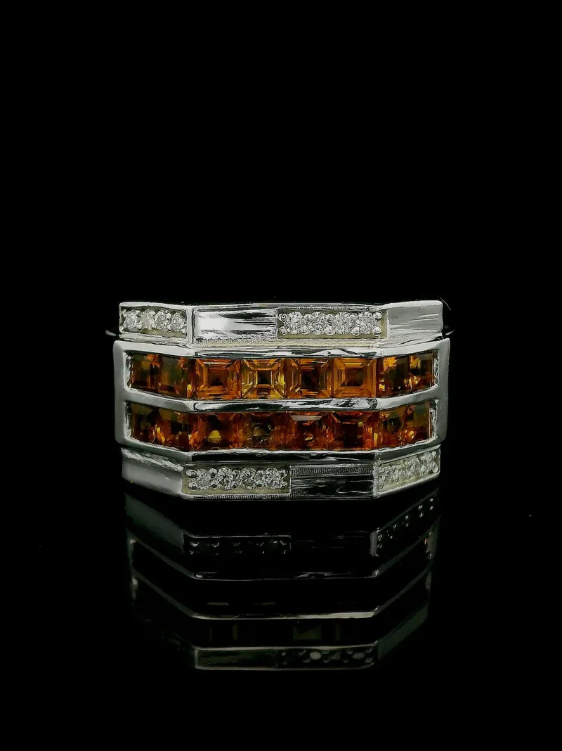 Elegant silver ring featuring orange gemstones and diamonds, perfect for men's wedding bands.